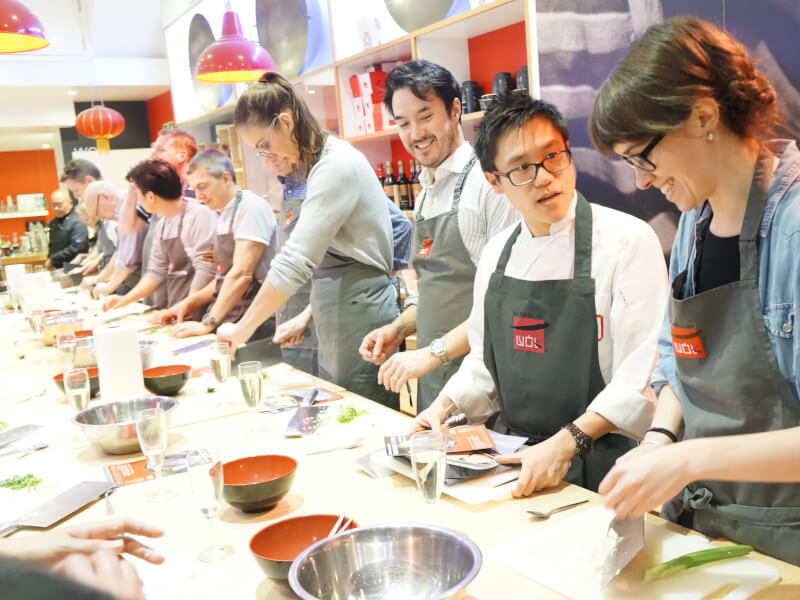 A group of people attend an Asian cooking class with School of Wok